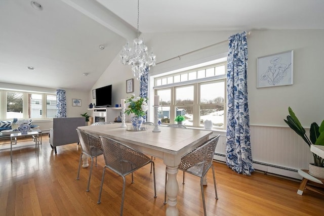 dining area featuring a wainscoted wall, a notable chandelier, beamed ceiling, and light wood finished floors