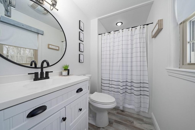 full bathroom with curtained shower, vanity, toilet, and wood finished floors