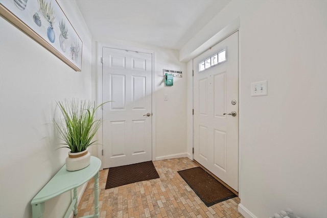 foyer featuring baseboards