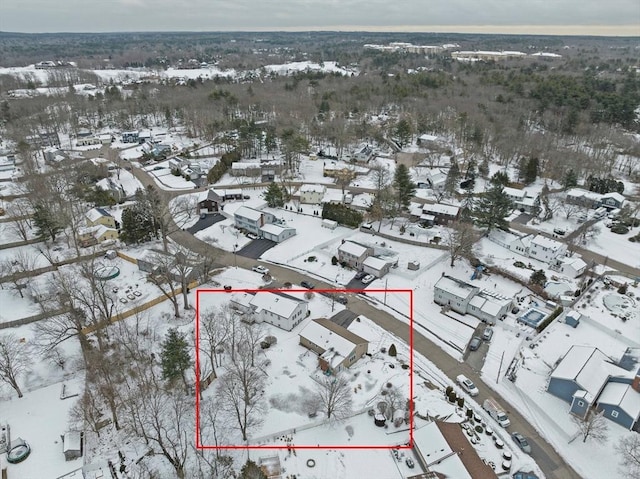 snowy aerial view with a residential view