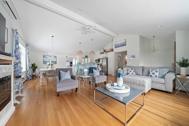 living area with a high end fireplace, beam ceiling, light wood-style flooring, and ceiling fan with notable chandelier