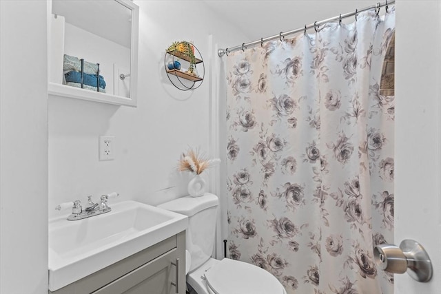 bathroom with vanity, toilet, and walk in shower