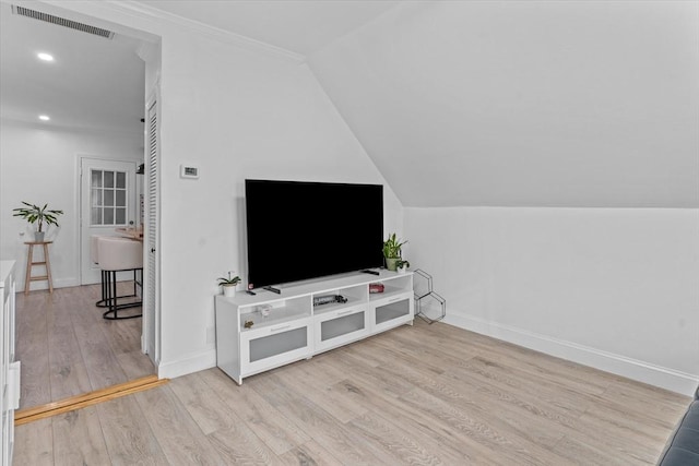 living room with crown molding, light hardwood / wood-style floors, and vaulted ceiling