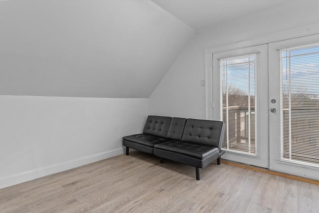 sitting room featuring light hardwood / wood-style floors and lofted ceiling