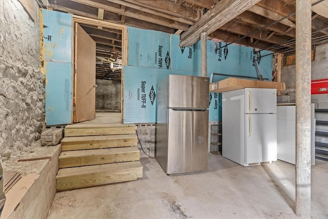 basement with white fridge and stainless steel fridge