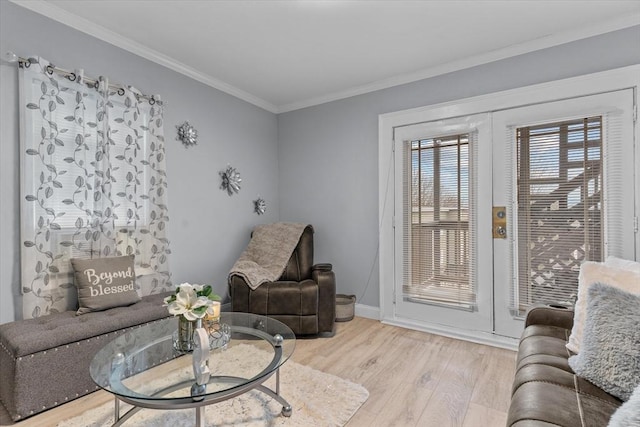 living room featuring french doors, light hardwood / wood-style floors, and ornamental molding