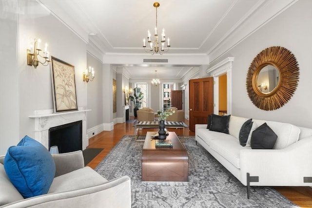 101 Pinckney St, Boston, MA 02114 - living room with a chandelier, baseboards, wood finished floors, a high end fireplace, and ornamental molding