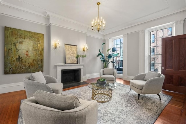 101 Pinckney St, Boston, MA 02114 - living room with crown molding, a fireplace with flush hearth, wood finished floors, and a chandelier