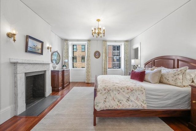101 Pinckney St, Boston, MA 02114 - bedroom featuring baseboards, wood finished floors, a chandelier, and a premium fireplace