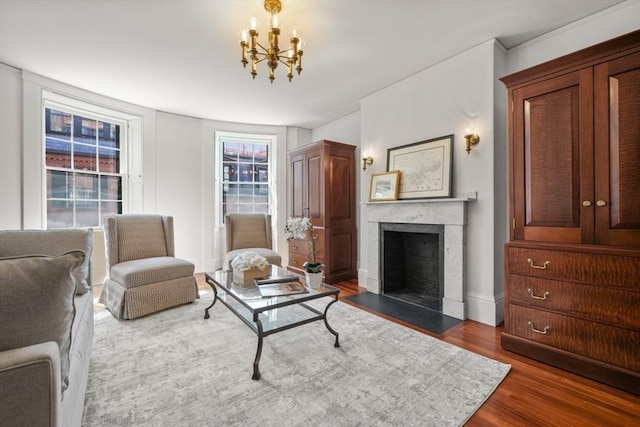 101 Pinckney St, Boston, MA 02114 - living area with a premium fireplace, wood finished floors, and a notable chandelier