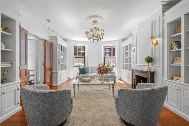 101 Pinckney St, Boston, MA 02114 - sitting room with ornamental molding, built in features, wood finished floors, and a chandelier