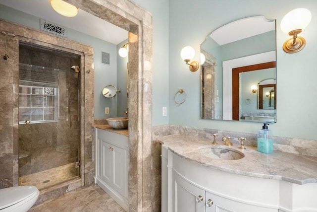 101 Pinckney St, Boston, MA 02114 - full bathroom with visible vents, two vanities, a sink, and a stall shower