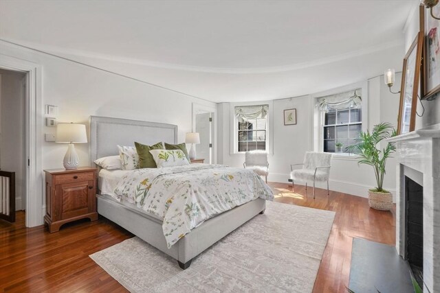 101 Pinckney St, Boston, MA 02114 - bedroom featuring baseboards, a fireplace with flush hearth, and wood finished floors