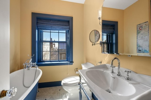 101 Pinckney St, Boston, MA 02114 - bathroom featuring a freestanding bath, a sink, baseboards, tile patterned floors, and toilet