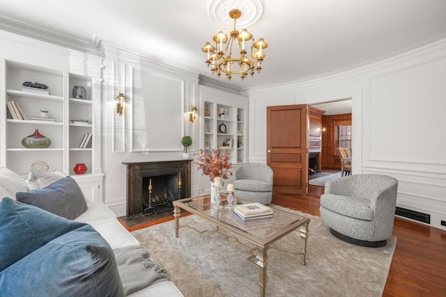 101 Pinckney St, Boston, MA 02114 - living room featuring crown molding, a notable chandelier, built in features, and wood finished floors