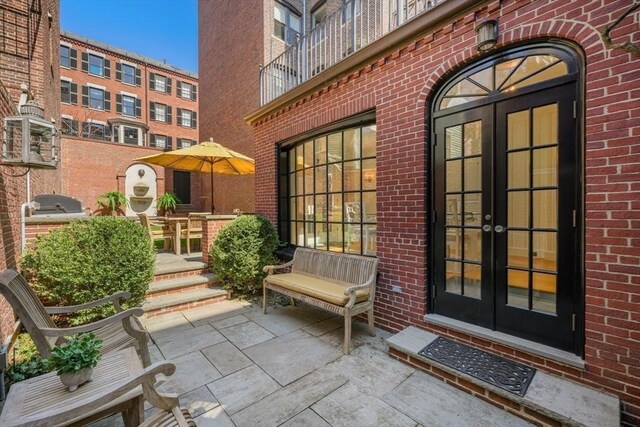 101 Pinckney St, Boston, MA 02114 - doorway to property with brick siding and french doors