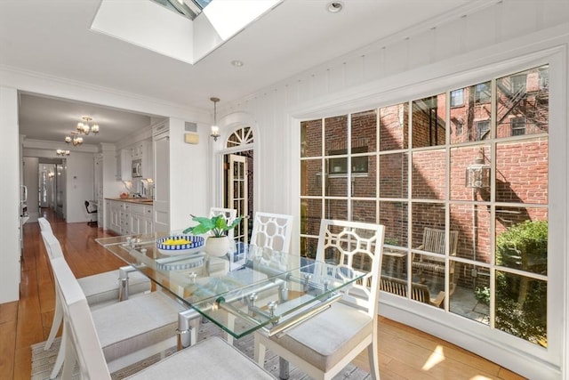 101 Pinckney St, Boston, MA 02114 - dining space with crown molding, a skylight, and hardwood / wood-style flooring