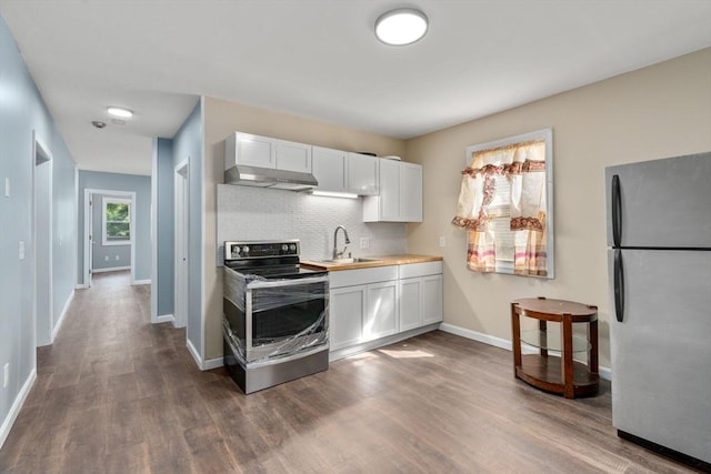 404-406 Franklin St, Springfield, MA 01104 - kitchen featuring stainless steel appliances, a sink, wall chimney range hood, dark wood-style floors, and white cabinets