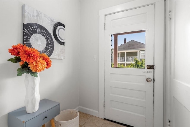 doorway with light tile patterned floors