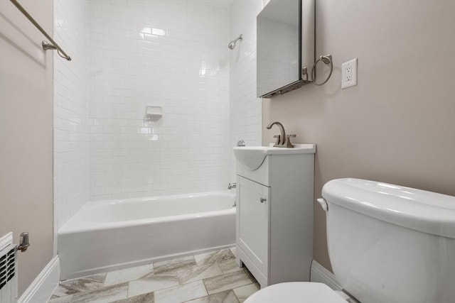 full bathroom with tiled shower / bath combo, vanity, and toilet