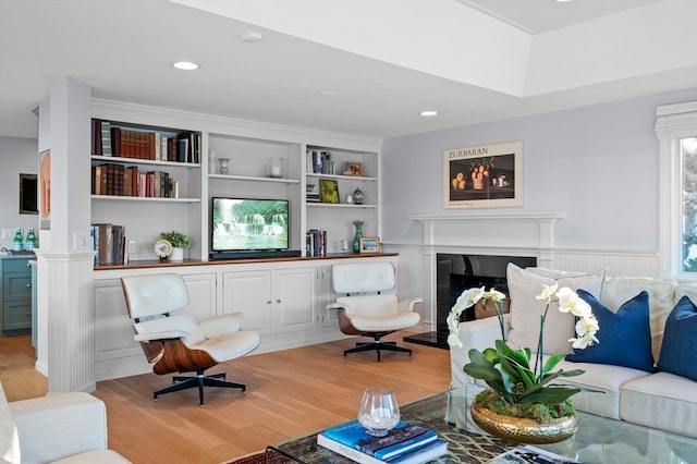 living room featuring light hardwood / wood-style flooring and built in features