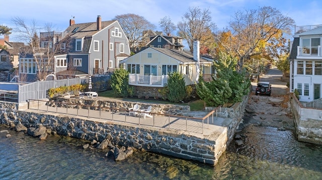 rear view of property featuring a water view