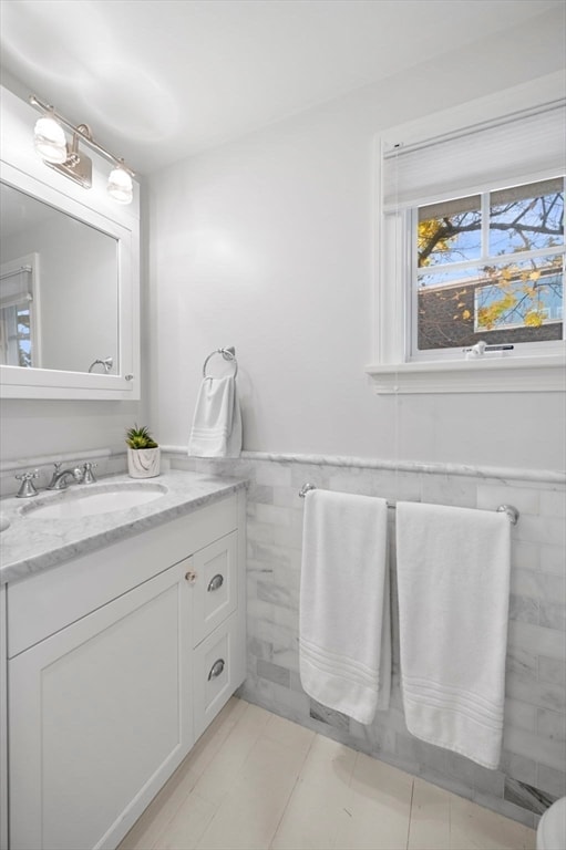 bathroom featuring tile walls and vanity