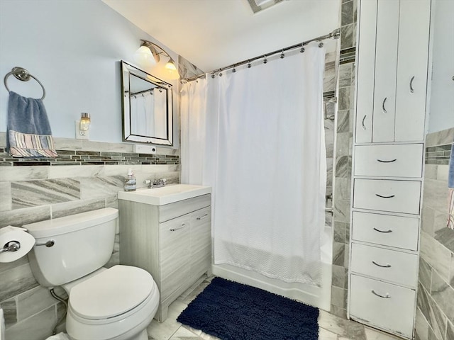 full bathroom featuring vanity, tile walls, shower / tub combo, and toilet