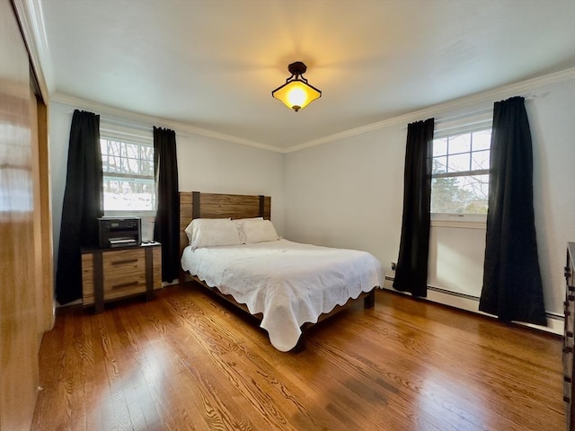 bedroom featuring crown molding and hardwood / wood-style floors