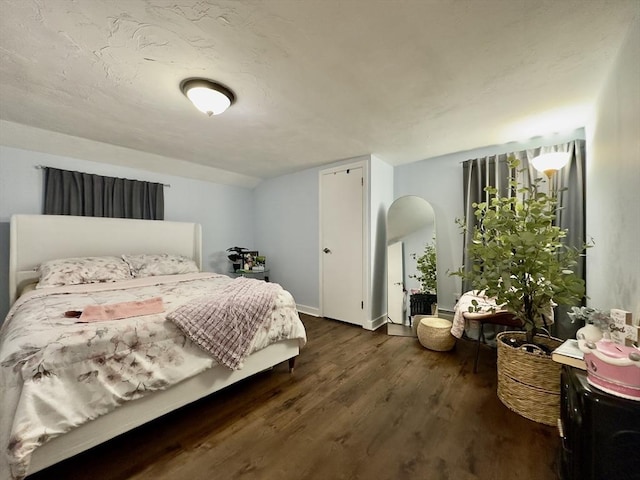 bedroom featuring vaulted ceiling and dark hardwood / wood-style floors