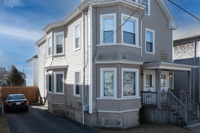 view of front of home featuring fence