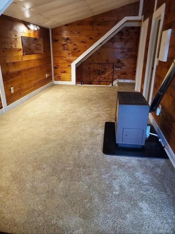 exercise room featuring wooden walls and carpet floors