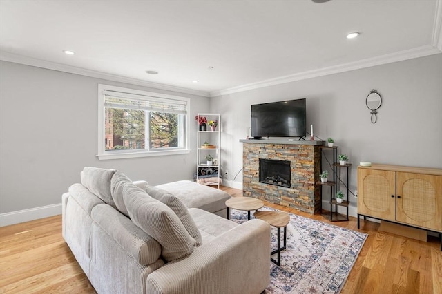 293 D St Unit 2, Boston, MA 02127 - living room featuring wood finished floors, a stone fireplace, ornamental molding, and recessed lighting
