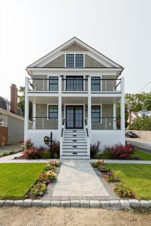 view of front of property featuring a balcony and covered porch