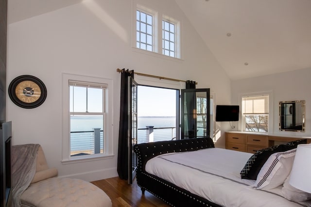 bedroom with dark wood-type flooring and high vaulted ceiling