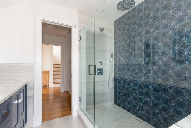 bathroom with tile floors, vanity, and an enclosed shower