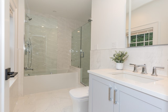 full bathroom with toilet, large vanity, enclosed tub / shower combo, tile walls, and tile flooring