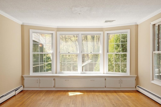 interior space with a textured ceiling, light wood-type flooring, and a baseboard radiator