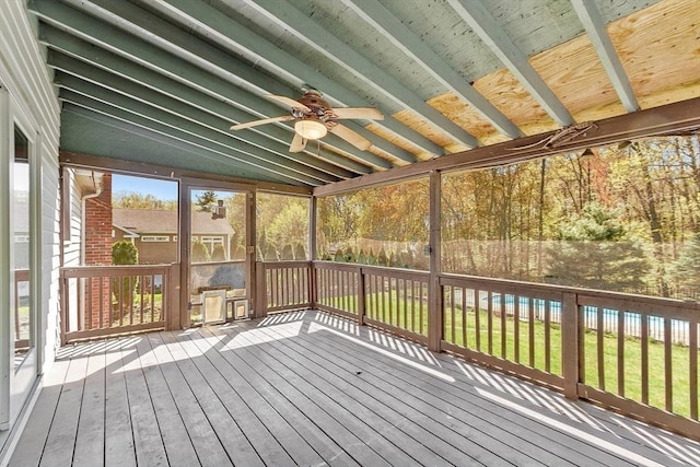 unfurnished sunroom featuring a ceiling fan
