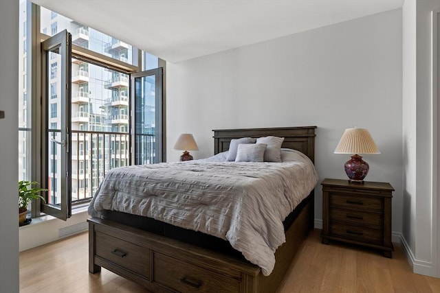 133 Seaport Blvd Unit 1710, Boston, MA 02210 - bedroom with light wood-style flooring, a wall of windows, multiple windows, and access to exterior