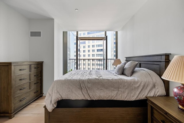 133 Seaport Blvd Unit 1710, Boston, MA 02210 - bedroom with visible vents, access to exterior, expansive windows, and light wood-type flooring