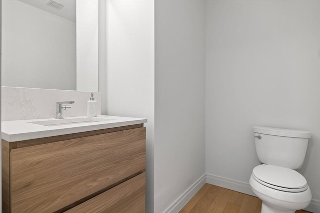 133 Seaport Blvd Unit 1710, Boston, MA 02210 - bathroom featuring visible vents, wood finished floors, baseboards, vanity, and toilet