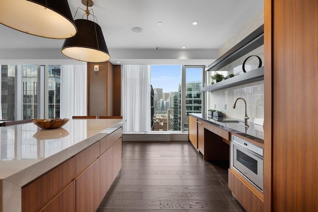 133 Seaport Blvd Unit 1710, Boston, MA 02210 - kitchen featuring open shelves, modern cabinets, a city view, dark wood-type flooring, and a sink