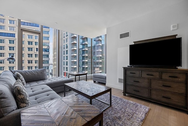 133 Seaport Blvd Unit 1710, Boston, MA 02210 - living room featuring baseboards, light wood-type flooring, expansive windows, and visible vents