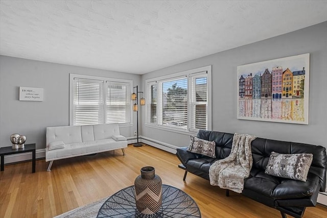 living room with baseboard heating and wood finished floors