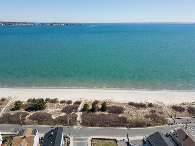 drone / aerial view featuring a water view and a beach view