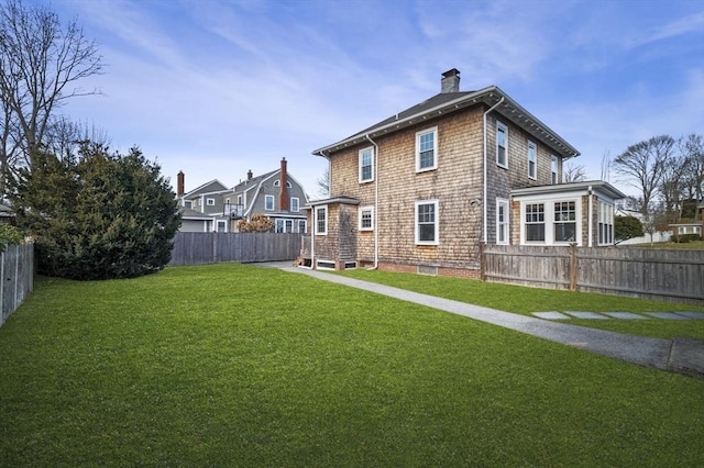 rear view of property featuring a yard