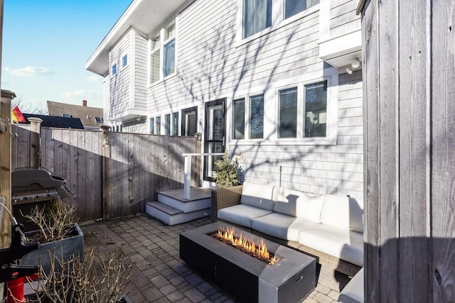 view of patio / terrace featuring area for grilling and an outdoor living space with a fire pit