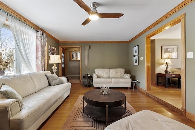 living room with crown molding, ceiling fan, wood-type flooring, and baseboard heating