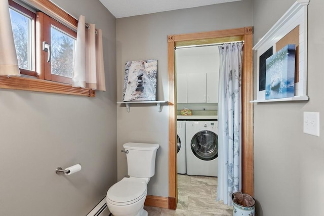 bathroom featuring independent washer and dryer and toilet